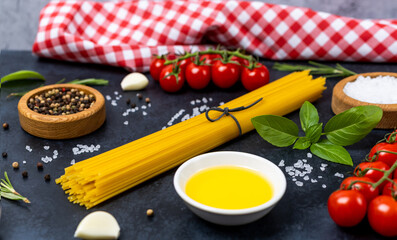 Food background from pasta, spices, herb on black table