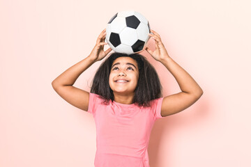 Little cute girl holding soccer ball isolated