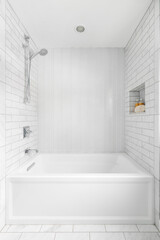 Naklejka na ściany i meble A bright, white shower with subway and herringbone tile lining the shower walls.