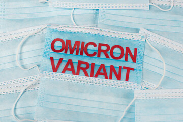 Top view of medical masks with red omicron variant lettering.