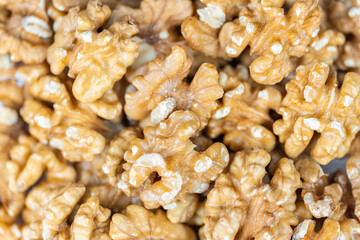 Heap raw peeled nuts in a macro, background and texture shot.