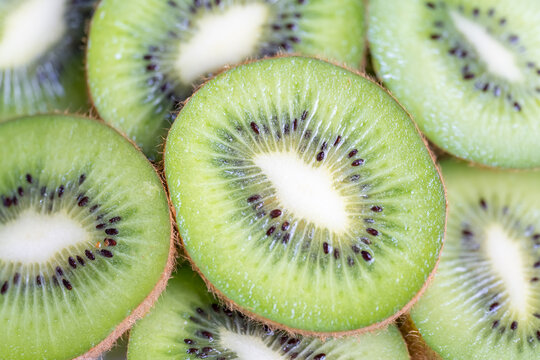 Stacked slices of kiwi fruit in a macro, background and texture photo shot.