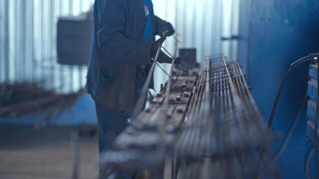 Professional welder works in a dark room with slow motion. Cinematic