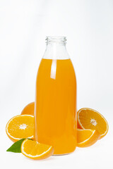 Orange juice glass bottle and oranges