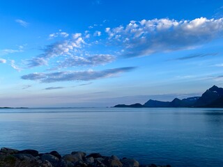 Fototapeta na wymiar Blue calm ocean bay horizon, small rocky islands, blue sky