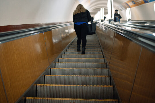 People Riding The Escalator In Metro Station.