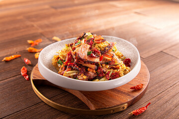Spicy chili cauliflower fried pork and bacon served dish isolated on wooden table top view of Hong Kong food