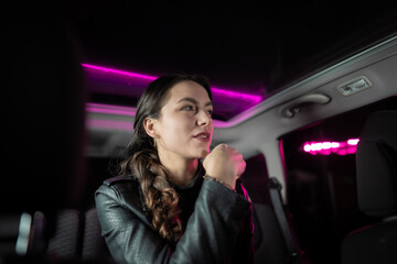 Fototapeta na wymiar Young businesswoman in the car at night. 