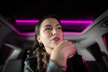 Fototapeta na wymiar Young businesswoman in the car at night. 