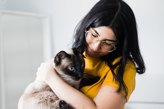Content woman hugging cute cat