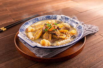 Hometown Fortune Soup of Egg Roll, Squid, Chicken, Pork, Bean Curd served dish isolated on wooden table top view of Hong Kong food