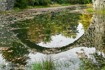 Reflection of the Rakotz Bridge or Devil's Bridge in the lake, Kromlau, Saxony, Germany