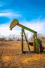 Fototapeta premium Rustic oil pump jack near Lake Fort Phantom Hill in Abilene, Texas, USA