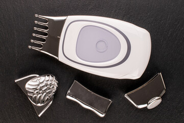 One galvanic spa machine with four nozzles on slate stone, macro, top view.
