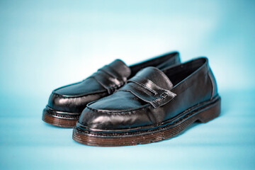 Detail of full black tassel shoes with rubber soles made of genuine cowhide with neat patterns...