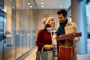 Cheerful woman has fun and enjoys in shopping day with her boyfriend in city.