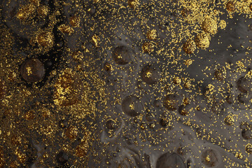 Flow pour oil and acrylic color painting blot. Abstract black and gold glitter texture background.