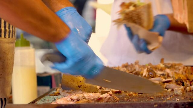 chefs cooking shawarma or kebab sandwich on a bar