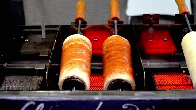 Hungarian chimney cakes spinning on the stove on a foodtruck stove
