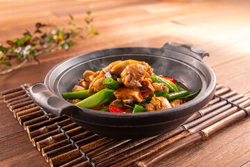Spicy Casserole ginger chicken served dish isolated on wooden table top view of Hong Kong food