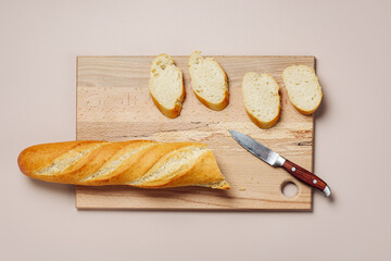 Sliced baguette on a cutting board.