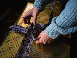 tying the bow on a wrapped gift