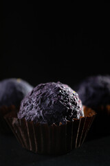 Colored round candies on a dark background
