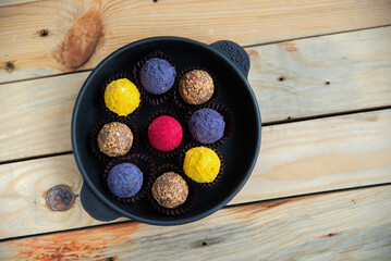 Sweets multicolored round on old wooden background