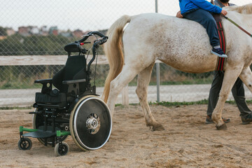 Wheelchair parked at an equine therapy center - obrazy, fototapety, plakaty