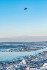 Helicopter over the frozen sea with ice floes. Hummock ice floes near the coast of IJsselmeer in Almere, the Netherlands.