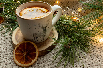 Obraz na płótnie Canvas Green tea in a craft cozy cup, dried fruit, orange and cinnamon stick