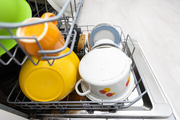 Dishes and cutlery on dishwashing machine. Clean dishes.
