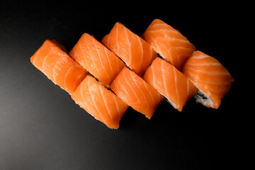 top view of Philadelphia sushi rolls with smoked salmon on a dark background