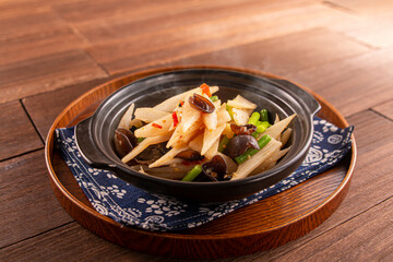 Chinese yam casserole with garlic core and black fungus served dish isolated on wooden table top...