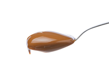 Spoon with dulce de leche, traditional sweet from Argentina isolated on white background.