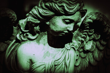 Retro styled image of ancient statue of guardian angel