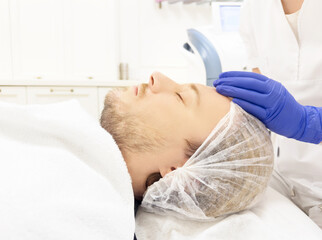 young man in the doctor's office for cosmetic procedures ,dermatologist offices,laser technology.