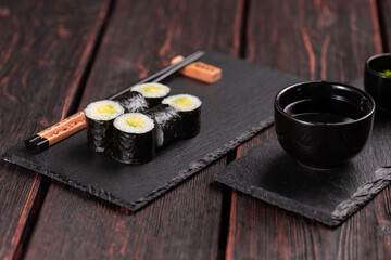 Maki sushi roll with avocado with chopsticks. Sushi menu. Japanese food.