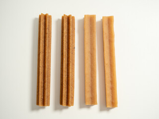 Dog teeth cleaning sticks. Puppy toothpick to reduce tartar formation on a white background.