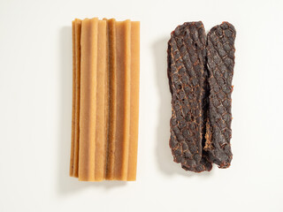 Dog teeth cleaning sticks. Puppy toothpick to reduce tartar formation on a white background.