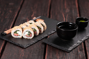 Sushi roll with salmon, green onion and cottage cheese with sesame - Sushi menu. Japanese food.