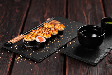 Japanese hot maki roll sushi with salmon - asian food concept
