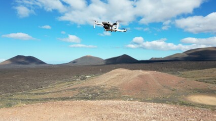 Fototapeta na wymiar fly the harmless ultralight drone weighing less than 250g in outdoor natural scenery in volcanic landscape - drone flying in protected natural area in Timanfatya national Park Lanzarote Canary