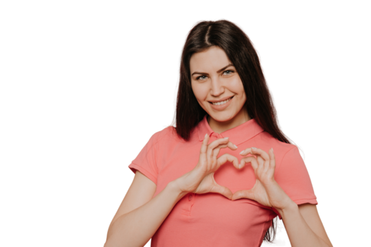 Portrait of attractive young hispanic woman with brunette hair making heart shape with hands and smiling friendly to camera, showing symbol of love and care. shot isolated on transparent background
