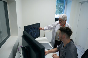 Colleagues diagnosticians analyze the results of MRI of the brain