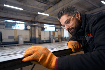 Close up photo of worker cutting with instrument