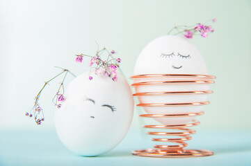 Easter eggs with painted face as concept for festive spring card..