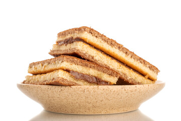 Two mini biscuits with cocoa on a ceramic saucer, macro, isolated on white background.