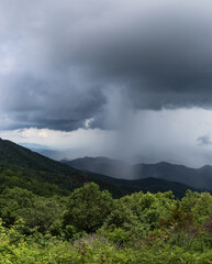 Fototapeta premium Tall panorama of an isolated cloudburst of rain, weather event with cloud copy space, vertical aspect