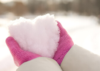 Snow heart in hands to St.Valentine's Day